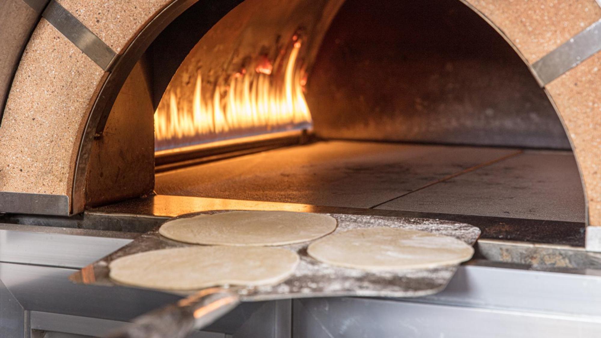 The Abdali Boulevard Hotel Amman Exterior photo Pizza dough in a wood-fired oven